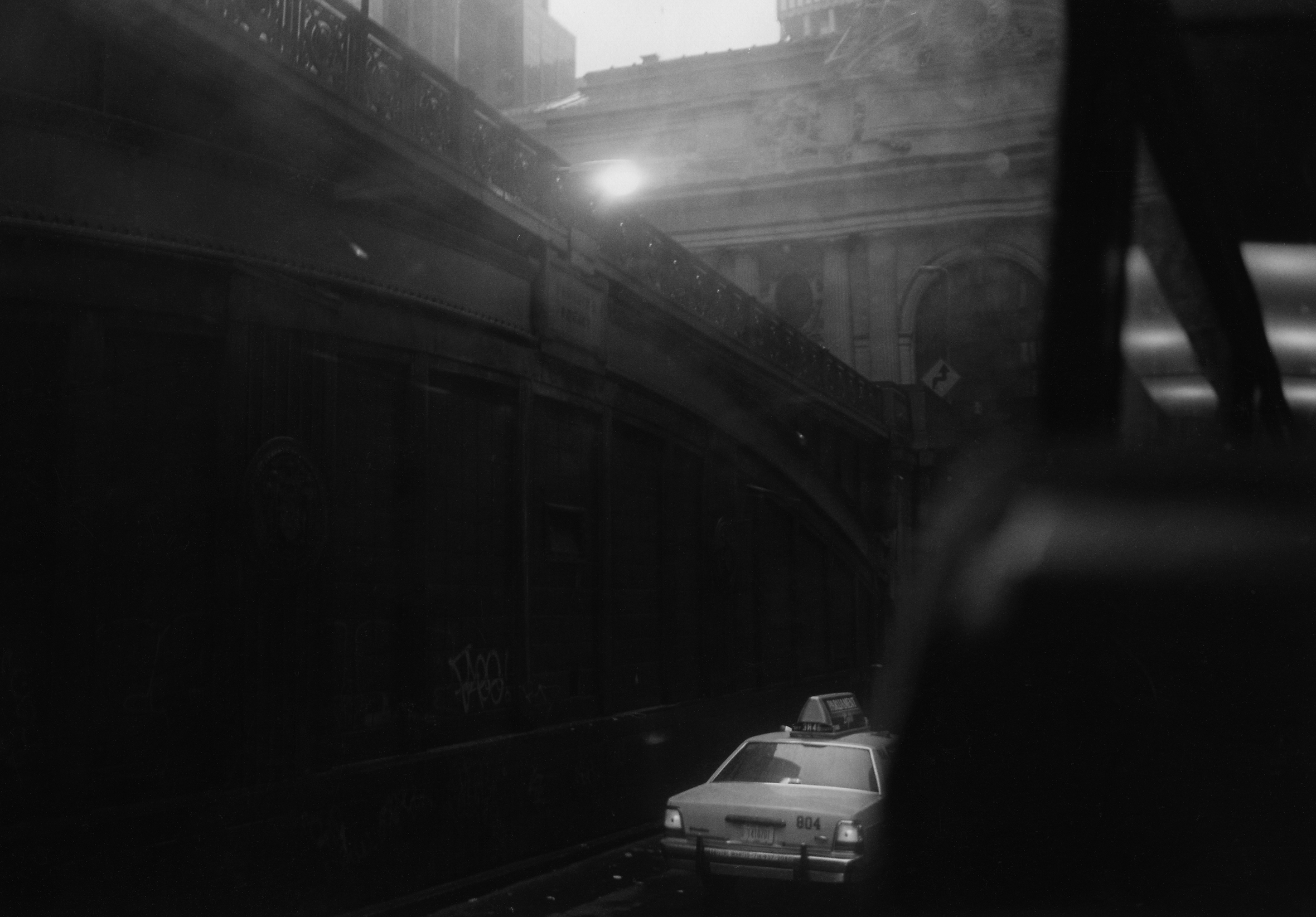 A taxi on a city street.