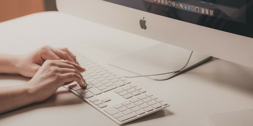 A woman typing an outreach email